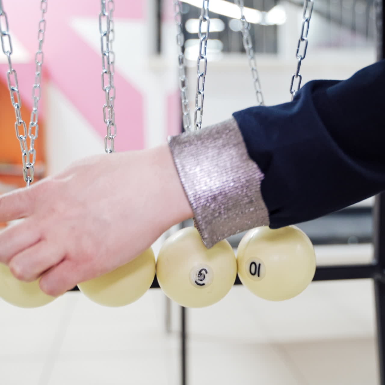 Newton's cradle showing laws of physics in motion. Museum of Science and newton pendulum