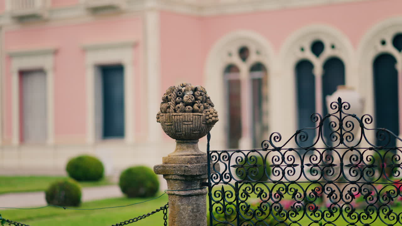 Close up of a decorative stone pillar in the courtyard of Villa Ephrussi de Rothschild with a blurred view on the background