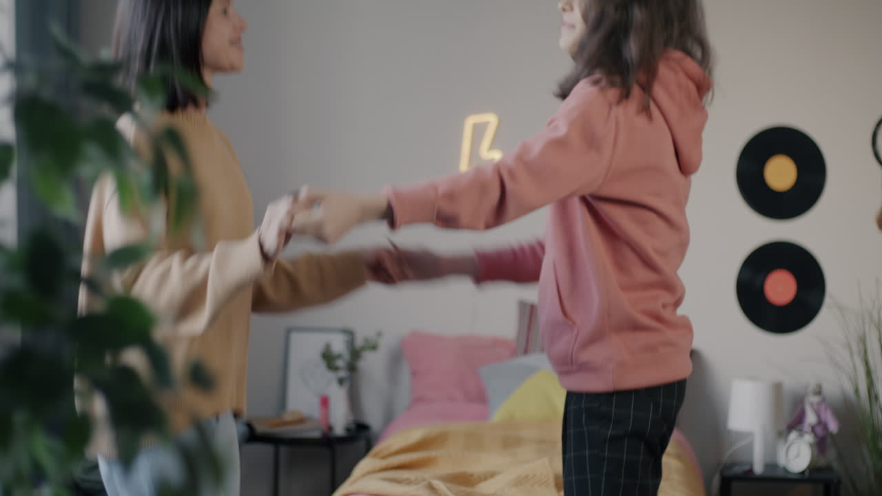 Two Women Dancing in a Cozy Bedroom