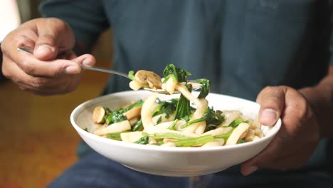 person eating a stir-fry