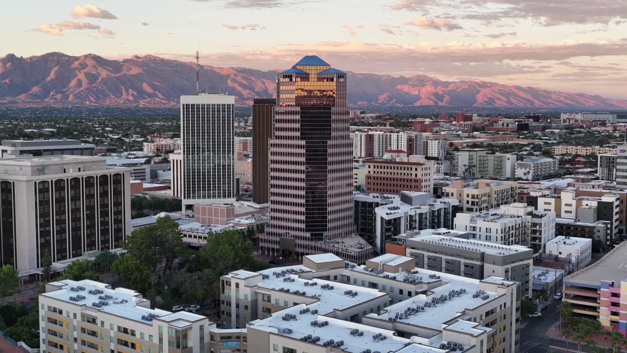 Circling pullback from downtown Tucson, Arizona by drone with Catalina Mountains in background