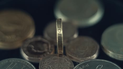close-up of one pound coin among other british coins