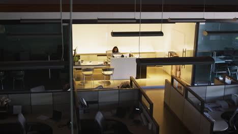 Young-businesswoman-working-in-empty-office,-elevated-view