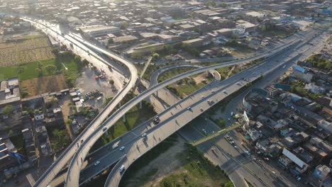 4k: drone flying over a traffic flyover with ongoing city traffic in punjab, pakistan