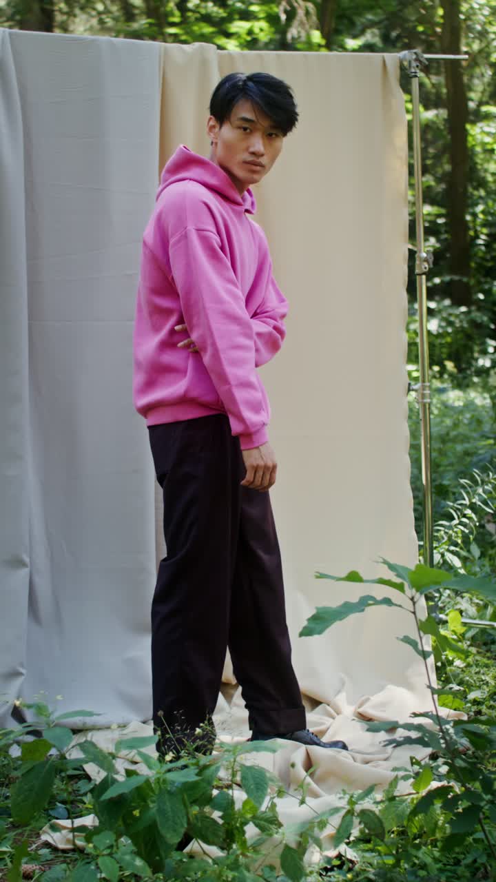 Man in Pink Hoodie in Forest Setting
