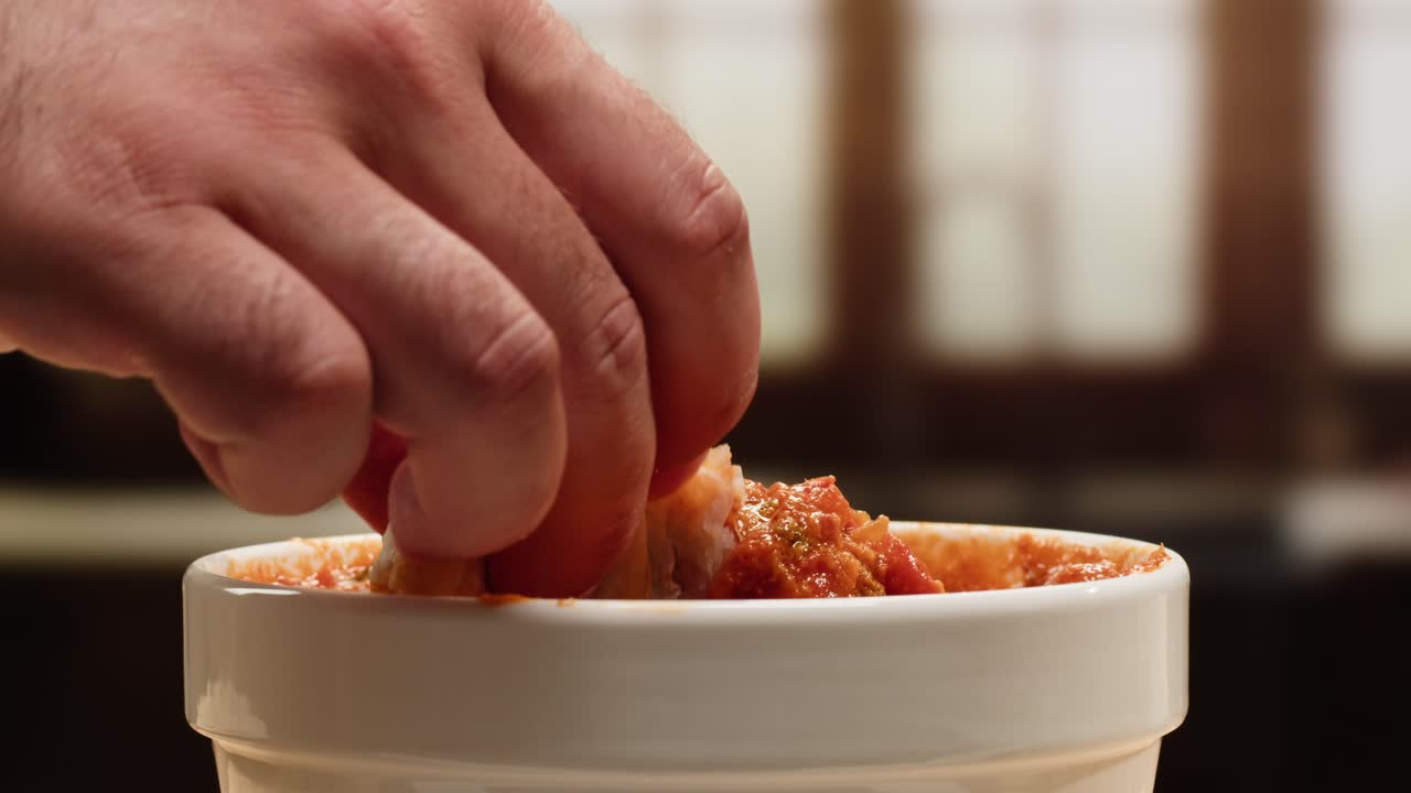 Dipping bread into sauce