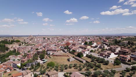 aerial view flying across the residential district of oropesa, spanish town in the province of toledo