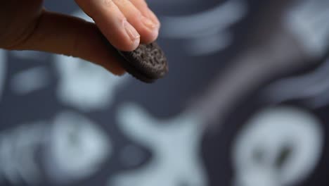 male tattoed hand adding chocolate cookies into a blender to make milkshake with camera movement