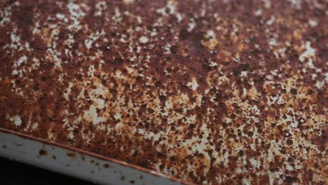 slow slide over rust pimples on the roof of an antique car