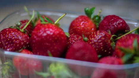 close up of some red berries in a box with a rotating shot