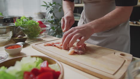 chef preparing raw chicken