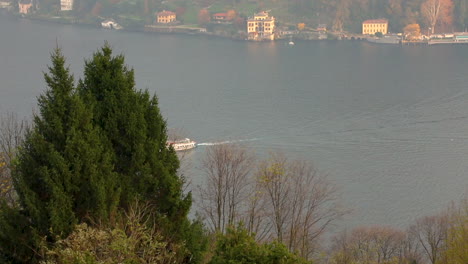 view of the boat from the hills on lake como in an emotional autumn day