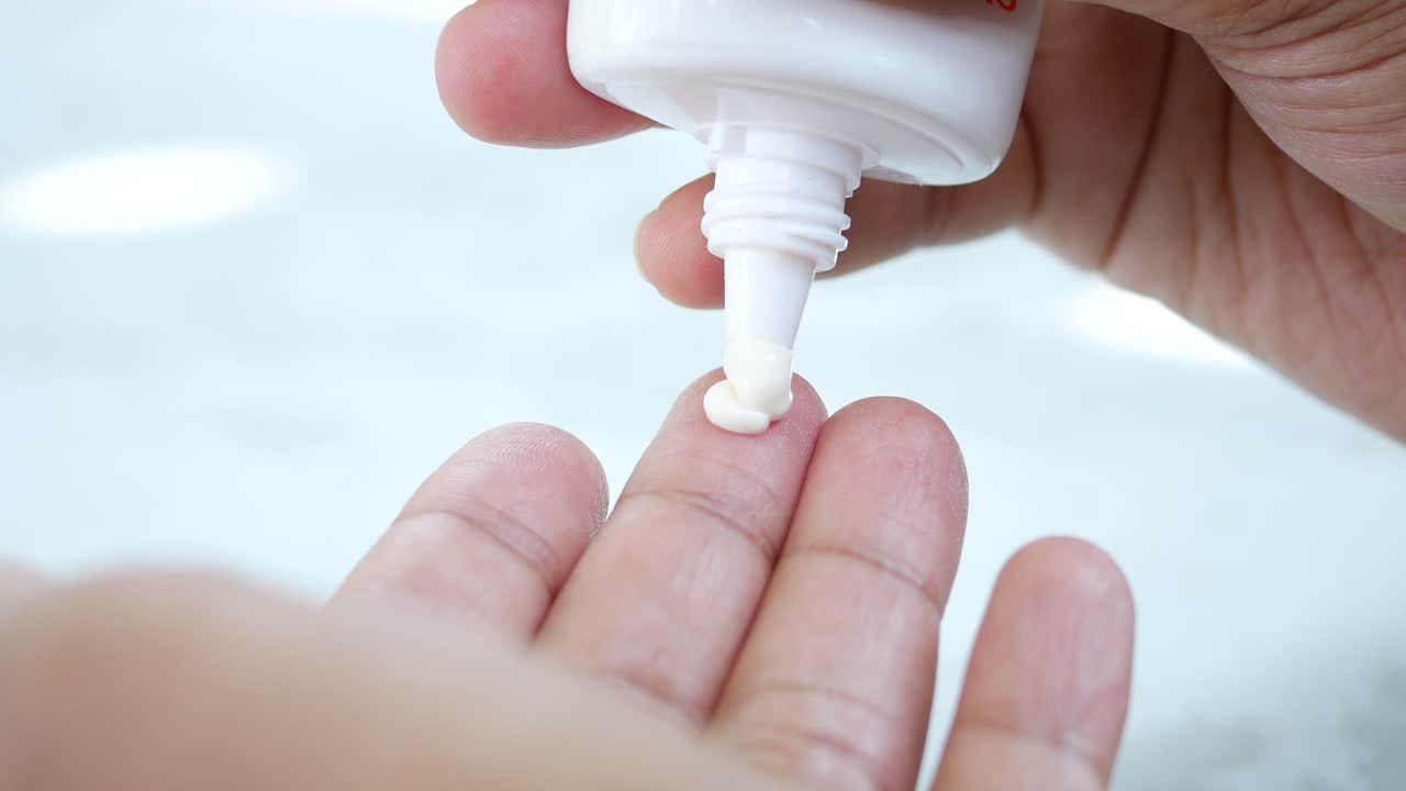 서브 스크린 크림을 사용하는 사람의 손