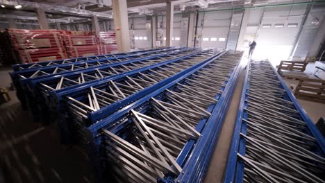 big and modern warehouse under construction, featuring metal shelving and other industrial equipment.