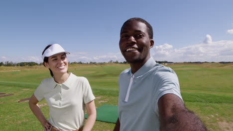 caucasian woman and african american man on the golf course.