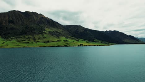 new zealand landscape aerial drone view of lush green mountains on lake