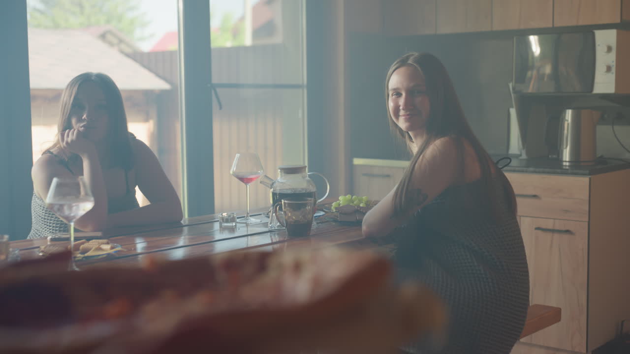 Beautiful moment with friends having a good time, smiling and enjoying each other's company over pizza, cozy indoor setting with natural light, laughter and warmth filling the room