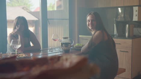 beautiful moment with friends having a good time, smiling and enjoying each other's company over pizza, cozy indoor setting with natural light, laughter and warmth filling the room