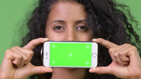 young beautiful hispanic woman showing phone