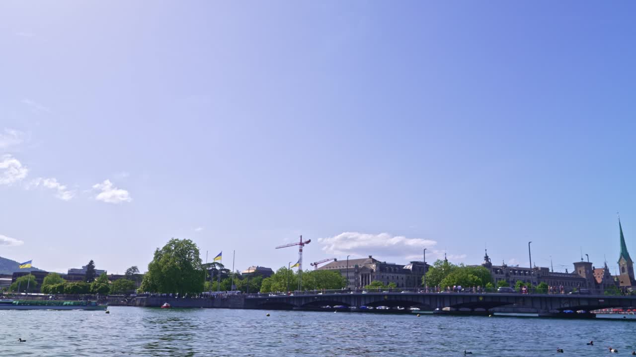 Lake Zürich with Quay Bridge an Limmat passenger ship passing on a sunny late spring day.