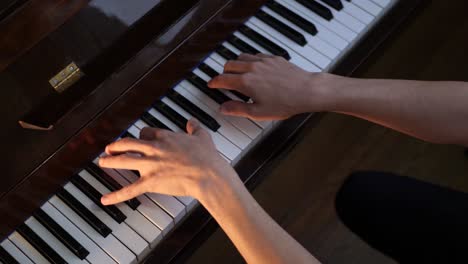 unrecognizable male musician playing piano