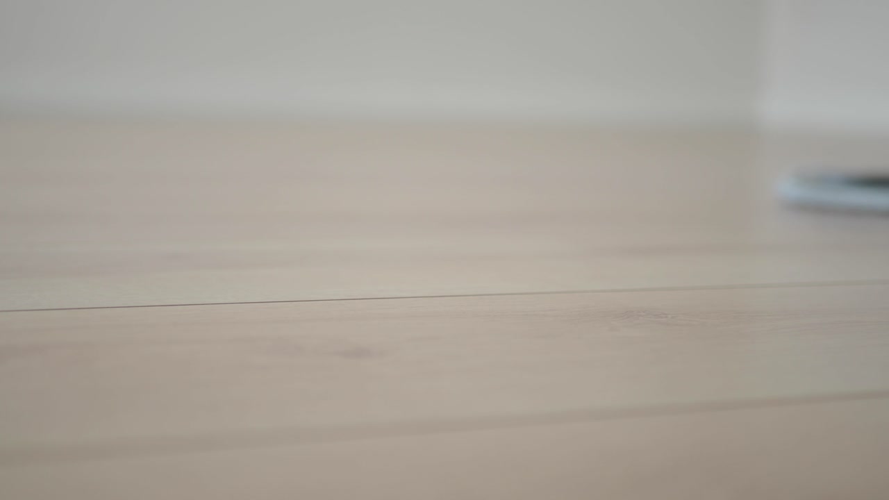 Cleaning a light wooden floor with a mop