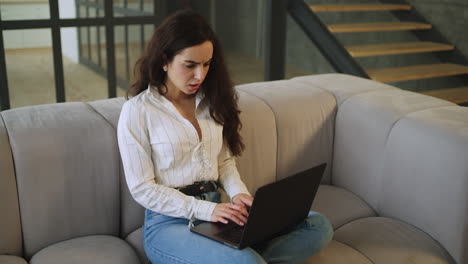 worried woman working on computer at home