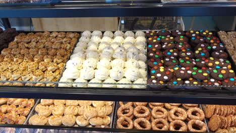 assorted pastries and cookies in a bakery display case