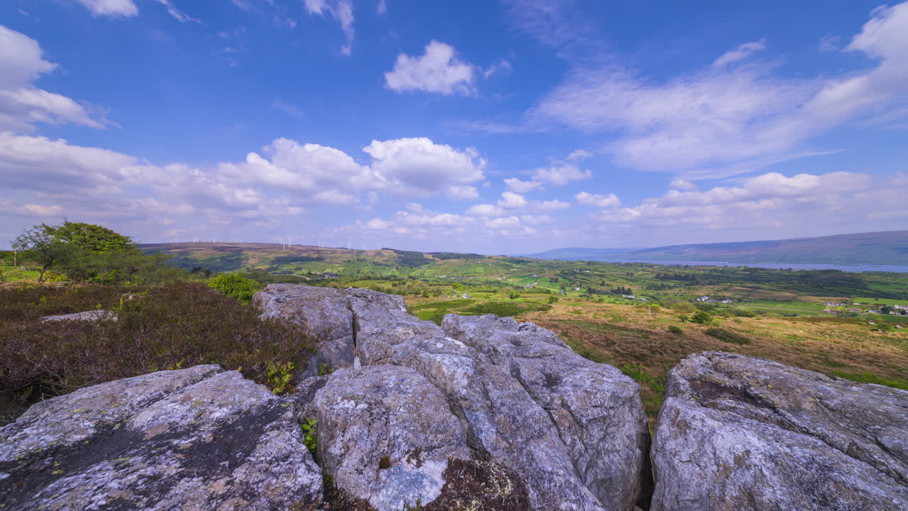 Time lapse of rural landscape with bedrock foreground and lake in the distance on a spring sunny cloudy day in Arigna mountains in county Leitrim in Ireland
