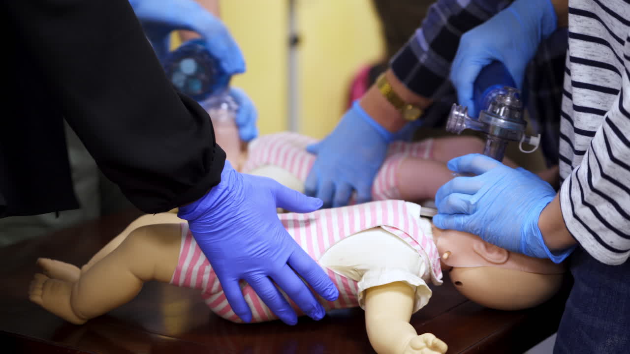 Medical practice on dummies. Students doing cardiopulmonology procedure on doll mannequins. Medical education concept. Close-up.