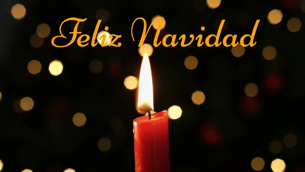 feliz navidad escrito sobre una vela encendida