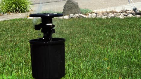 In-close-up-a-man-adjusts-a-high-grade-sprinkler