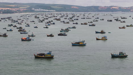 Aerial-flyover-crowded-sea-with-fishing-boats-during-cloudy-day-in-Vietnam---Overfishing-and-Climate-damage