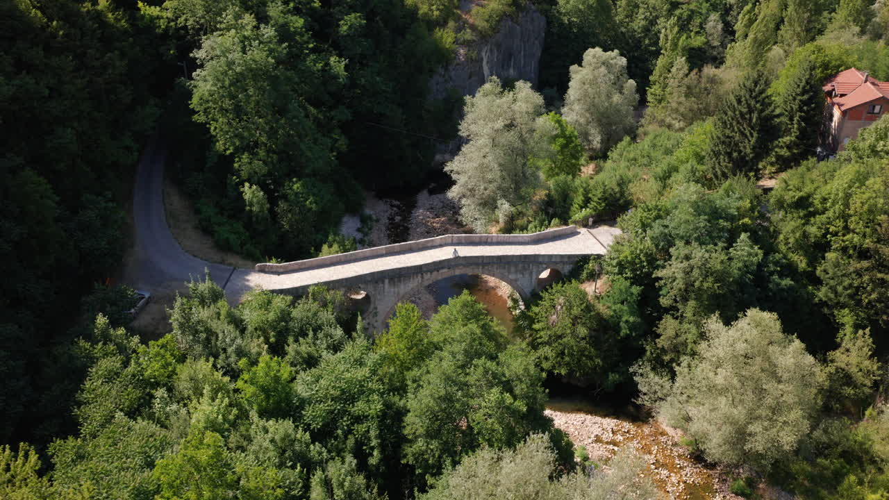 Aerial View Of Goat's Bridge With Man Walking On Stone Bridge In Sarajevo, Bosnia And Herzegovina - Drone Shot