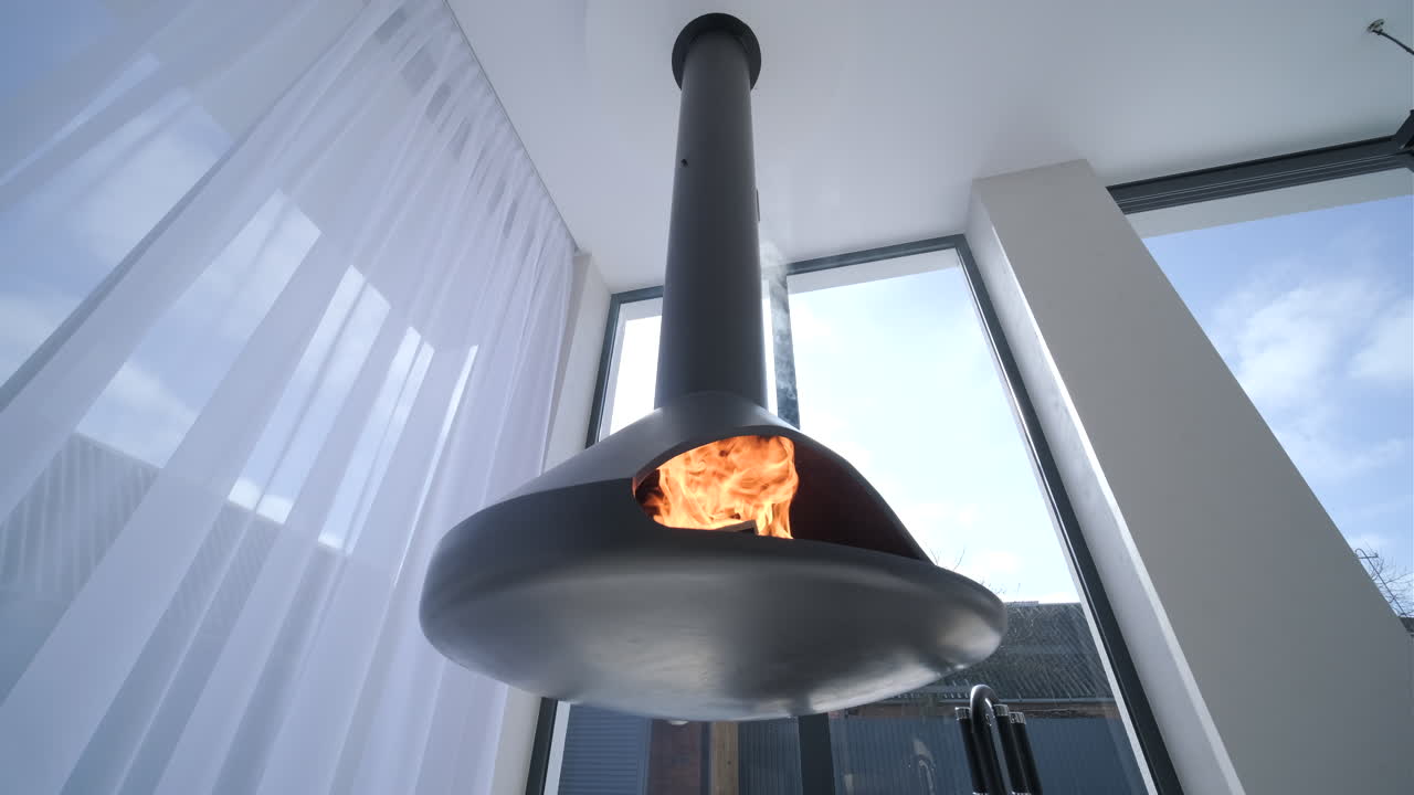 Modern Hanging Fireplace with Burning Fire and Sunlight Through Window