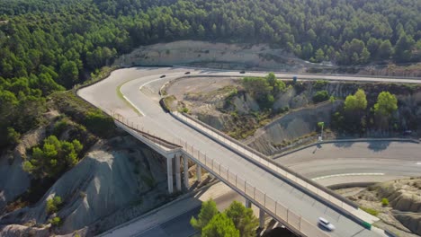 Castelloli-speed-circuit-winding-through-a-forested-landscape-in-barcelona,-aerial-view