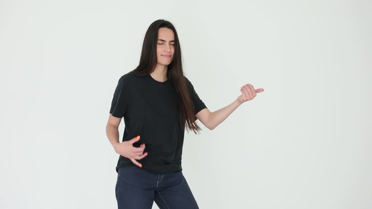 Woman playing air guitar in studio