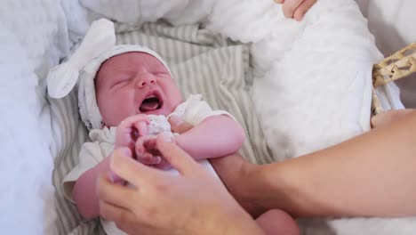 sweet baby girl in cozy blanket cared for by attentive adult a sweet baby girl in a cozy blanket is lovingly cared for by an attentive adult capturing cute moments