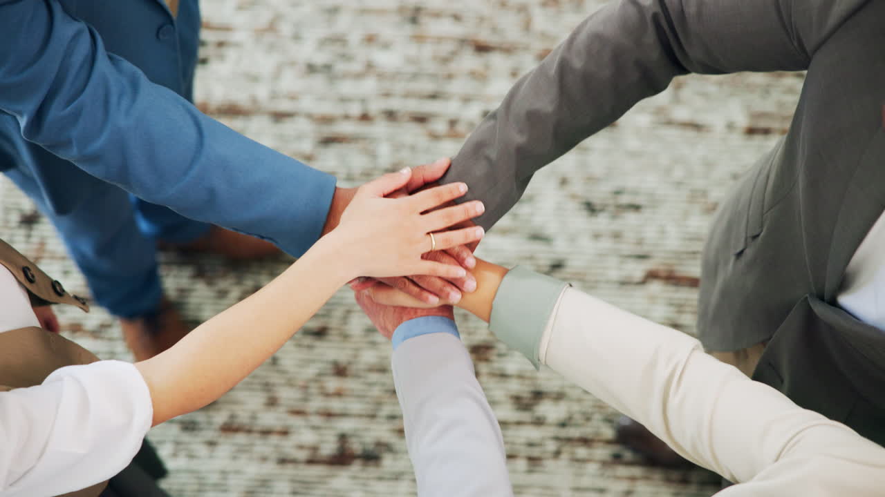 Diverse Business Team Stacking Hands in a Collaborative Huddle