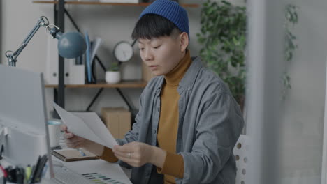 person working on design documents in modern home office