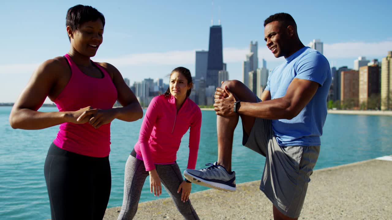 Multi Ethnic male and females stretching after exercise