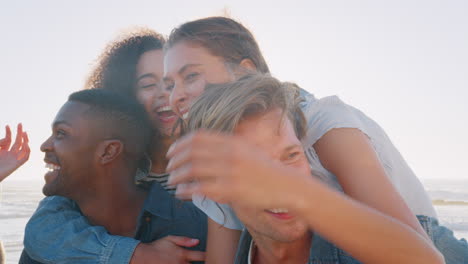 Portrait-Of-Men-Giving-Women-Piggyback-On-Summer-Beach-Vacation