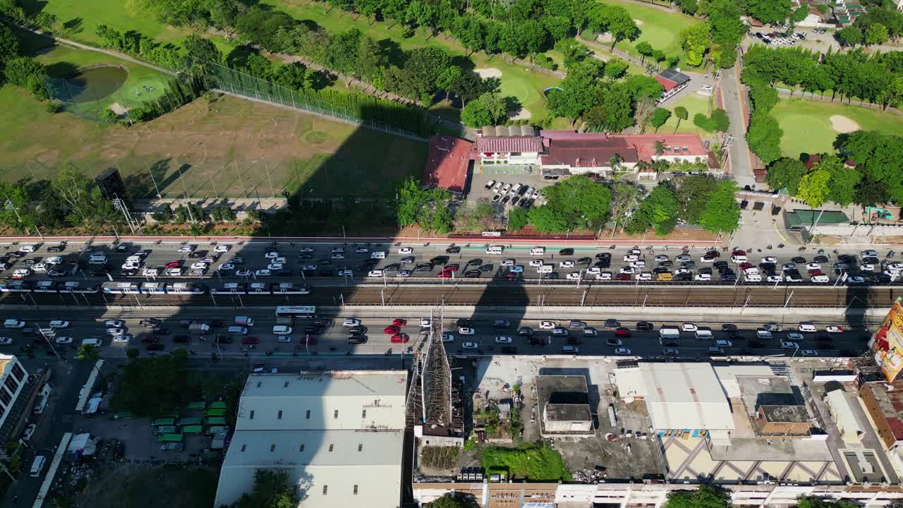 Aerial drone shot of bustling traffic at EDSA Epifanio de los Santos Avenue Highway during rush hour at Metro Manila, Philippines.