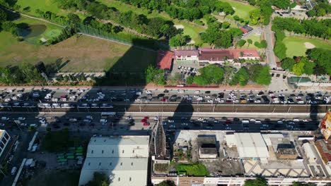 aerial drone shot of bustling traffic at edsa epifanio de los santos avenue highway during rush hour at metro manila, philippines.
