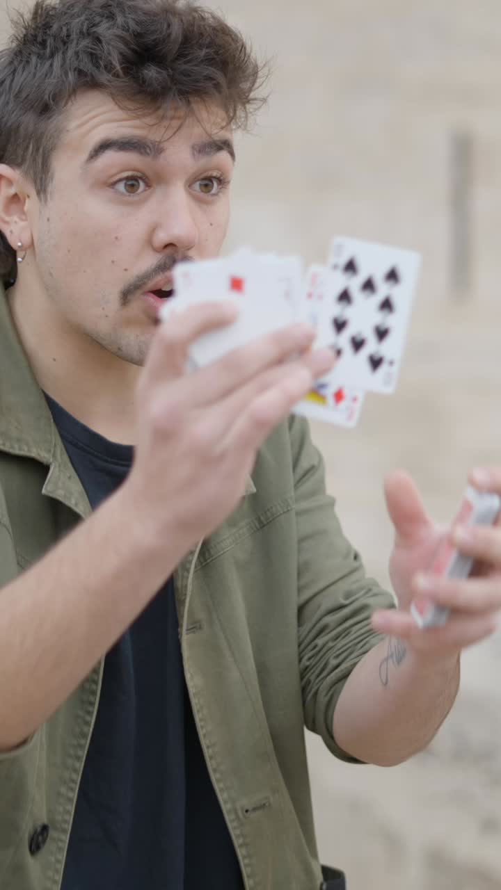 A man shuffling cards and expressing various emotions through speech and gestures