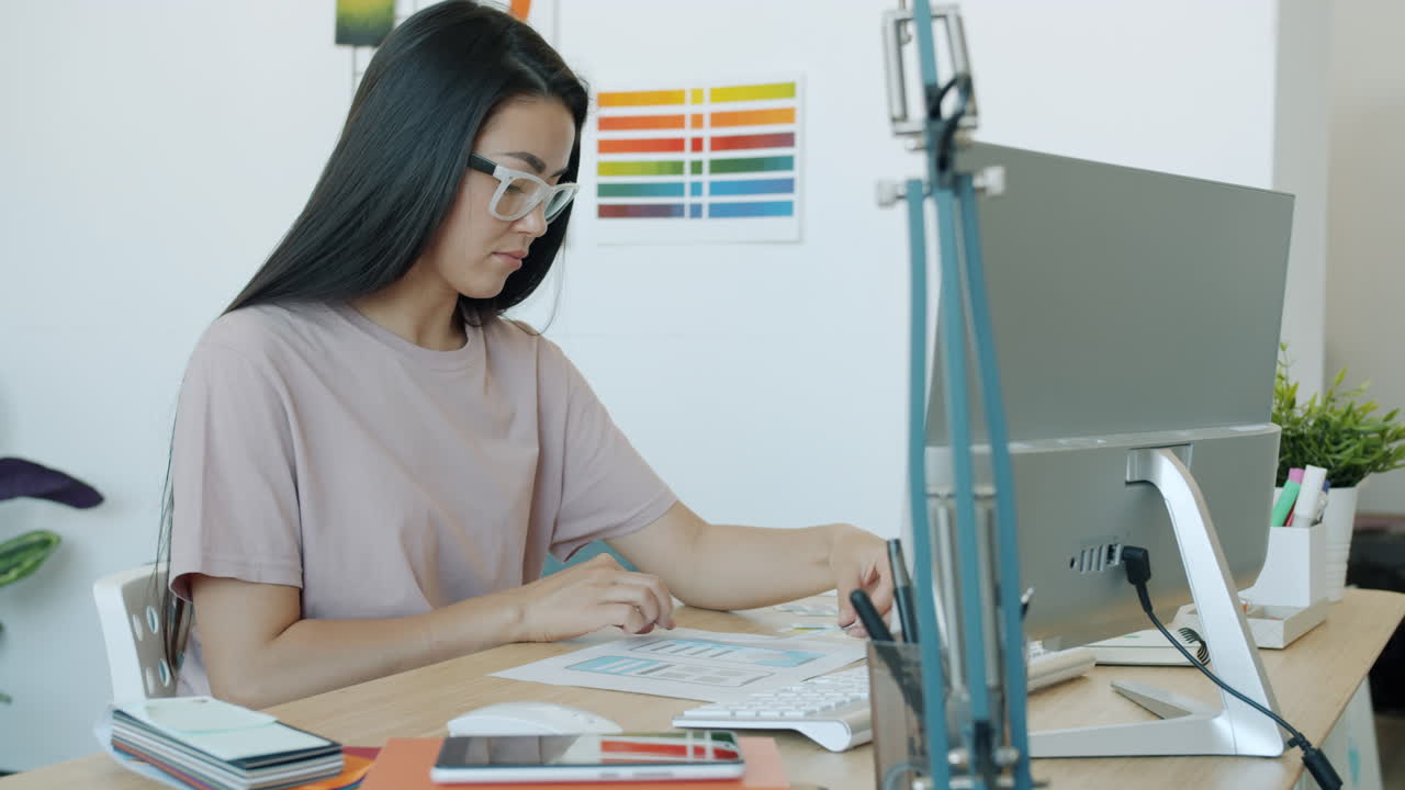 Woman working on a computer in an office.
