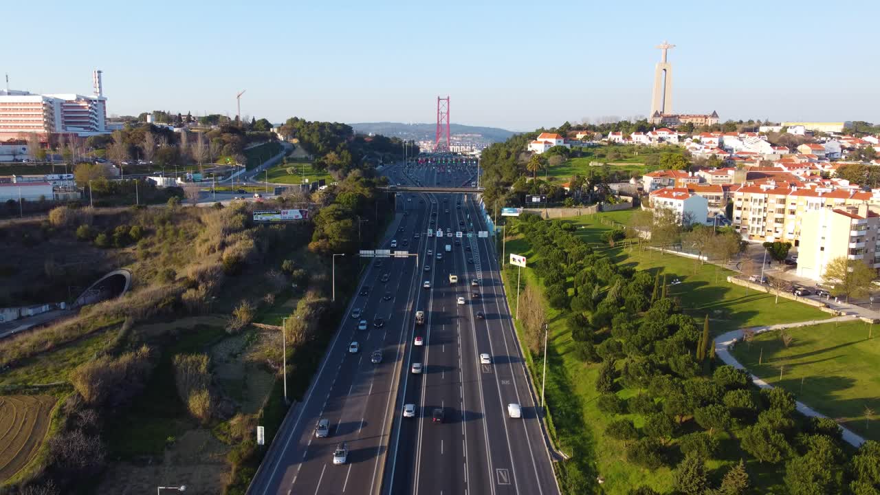 Drone shot flying backwards over a highway with Lisbon in the background