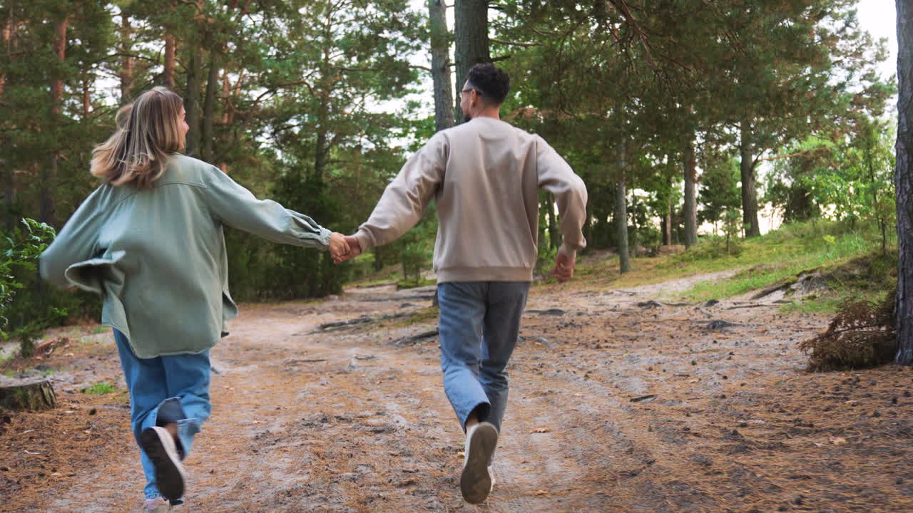 Couple running in the forest