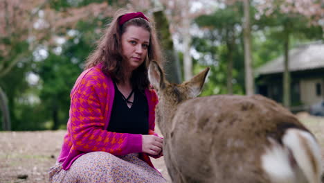 Woman-Feeding-Deer-In-Nara-Park,-Japan---Close-Up