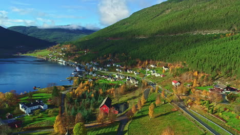 a rustic mountainous village landscape with a forest and a lake in norway